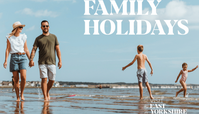 family walking and playing on an East Yorkshire beach, with the words "family holidays" superimposed