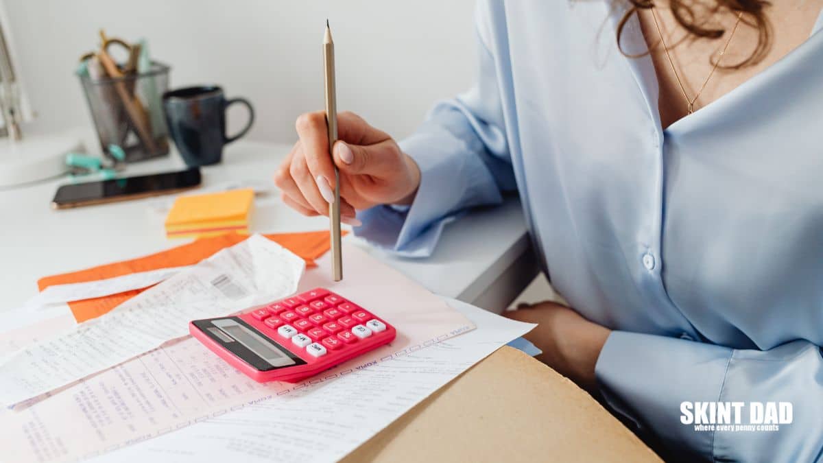 A Woman Computing Bills while Holding a Pencil