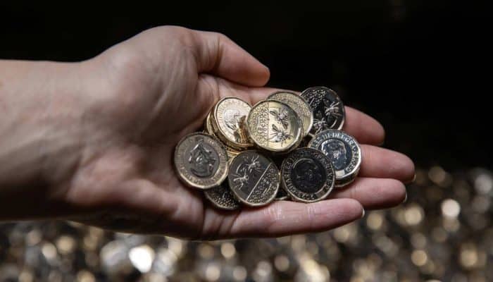 A handful of new Kind Charles III one pound coins