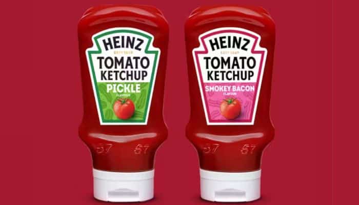 Two bottles of Heinz Ketchup. One is pickle flavour and the other is smokey bacon flavour