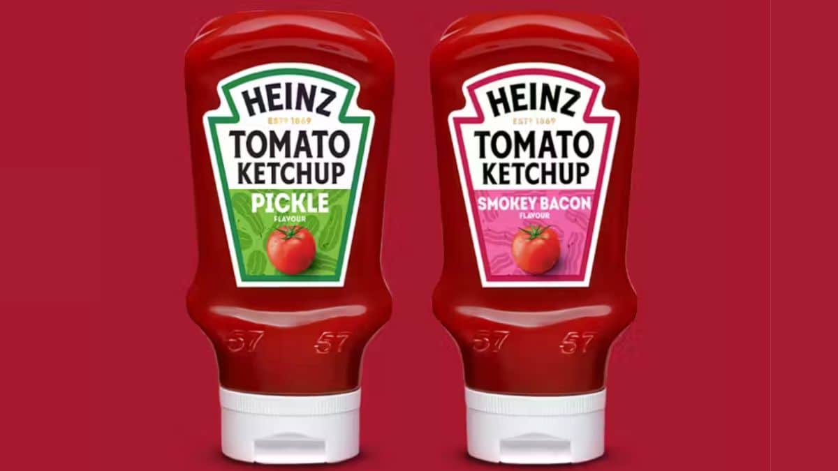 Two bottles of Heinz Ketchup. One is pickle flavour and the other is smokey bacon flavour