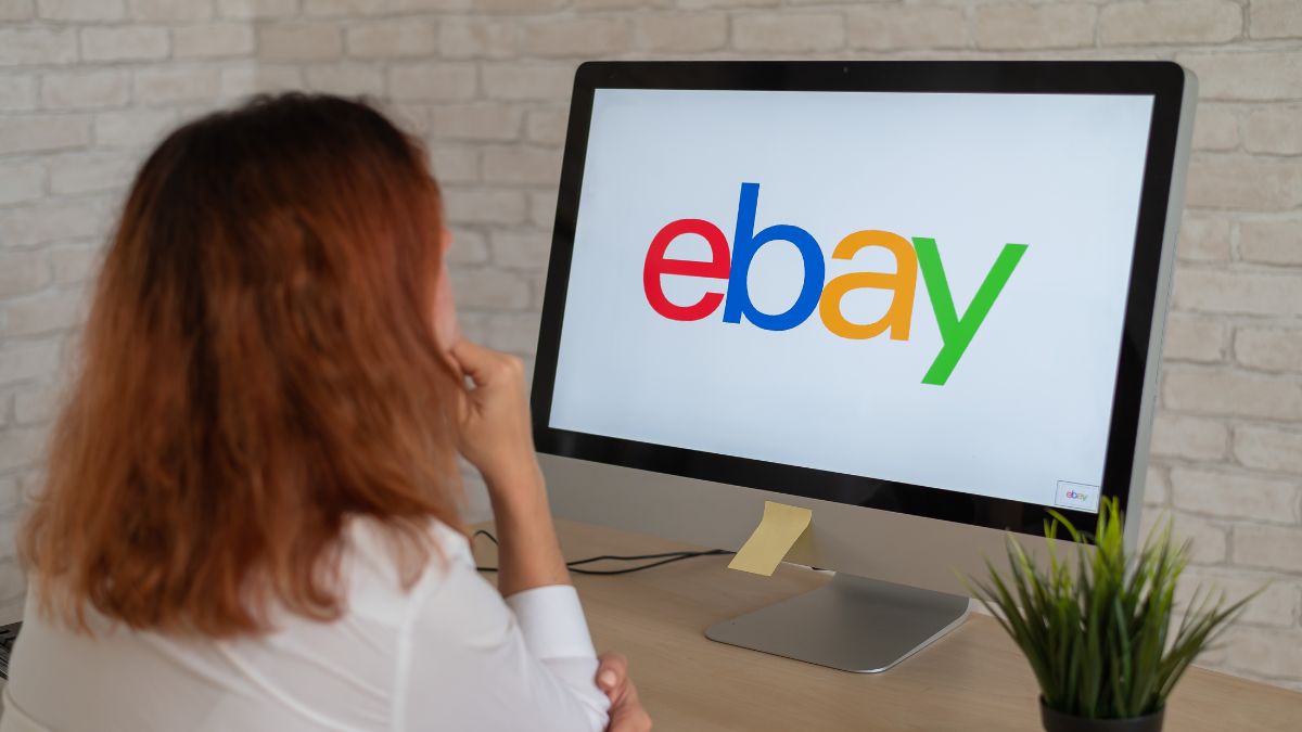 Woman looking at the eBay logo on a computer screen.