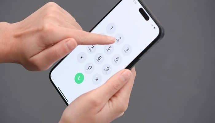 Man dialling 159 on a mobile phone