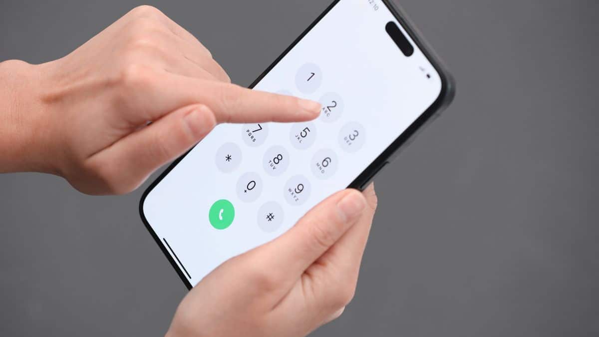 Man dialling 159 on a mobile phone