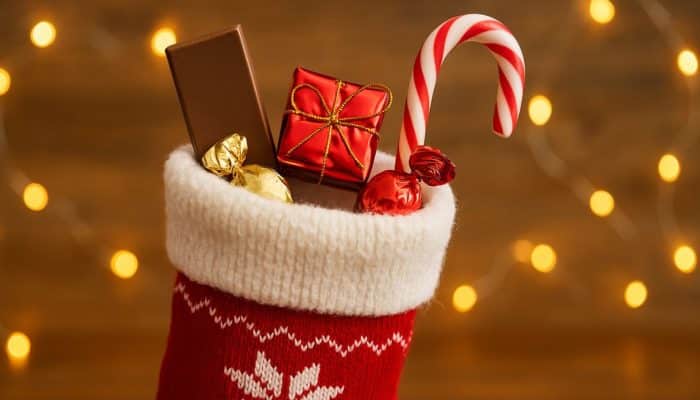 Christmas stocking filled with small festive treats like chocolate and sweets, shown as a simple budget-friendly stocking filler idea.