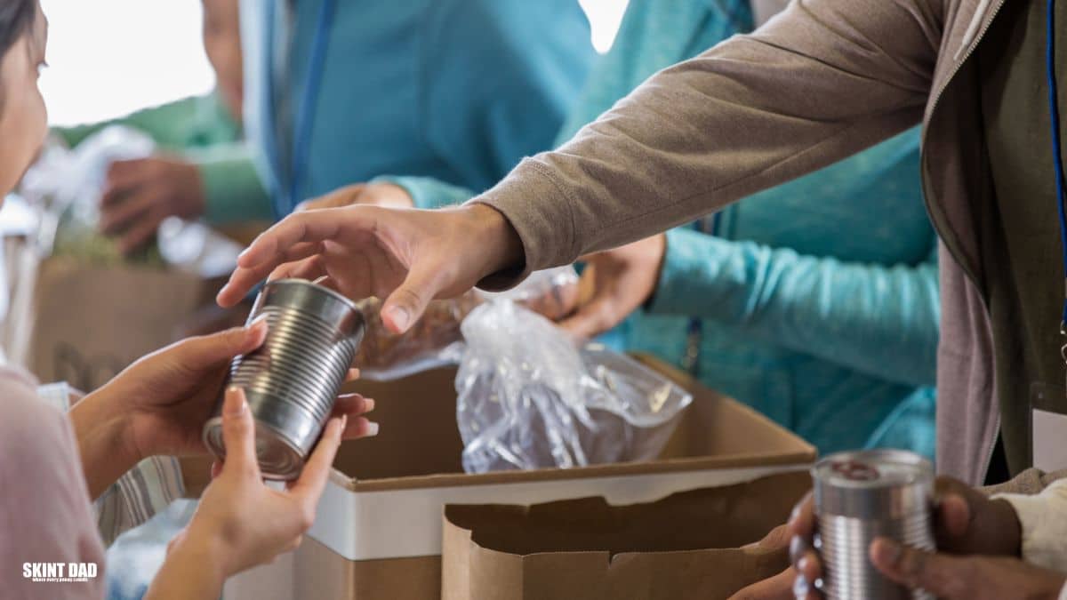 Volunteers sort food bank donations, placing tins and packets into boxes at a community centre, ready to help families in need this winter.