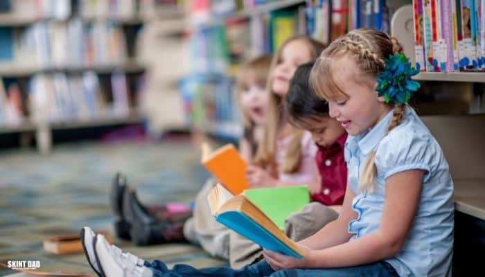 Children reading in a public library that offers free community space and support for families on tight budgets.