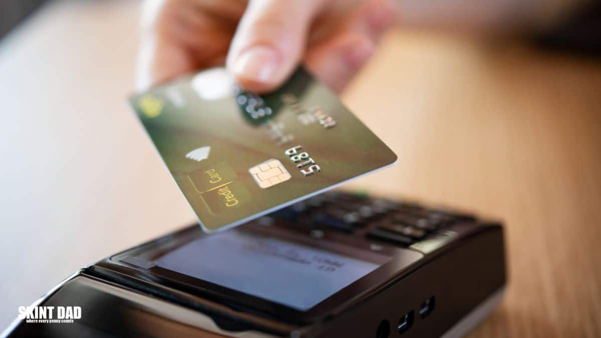 Shopper using a contactless bank card to pay.