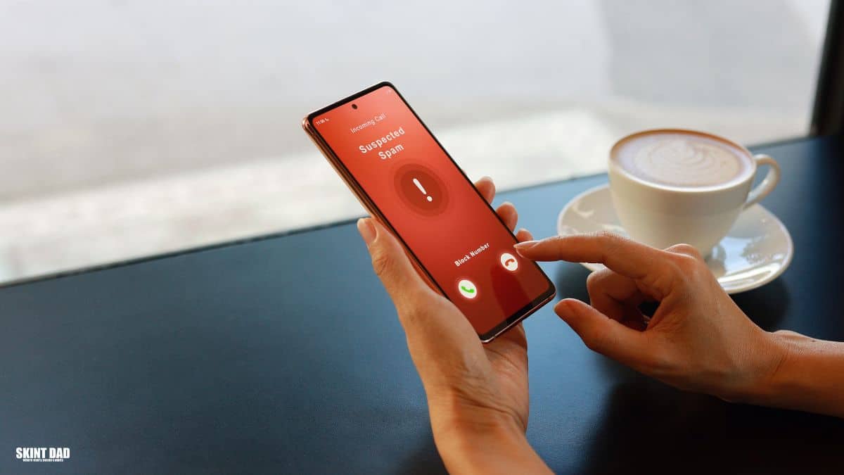 Person holding a mobile phone showing an incoming call from an unknown number, suggesting a suspected scam call.