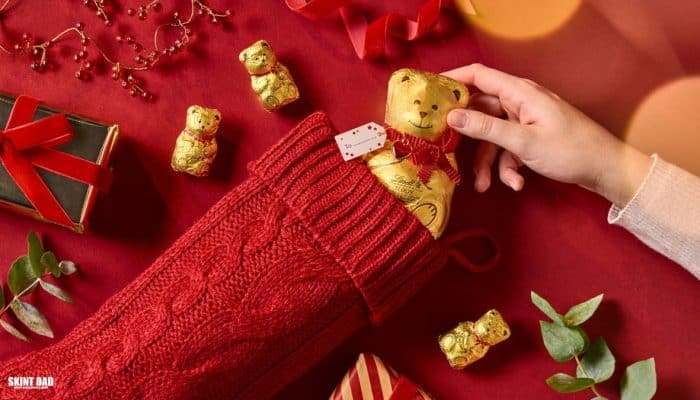 Person holding a Christmas stocking with a Lindt chocolate teddy inside during the festive giveaway in the UK