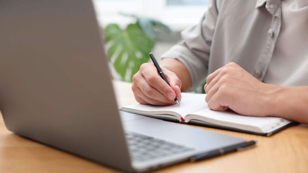 Person testing a website on a laptop at home, following simple tasks and giving feedback as part of a paid website testing side hustle.