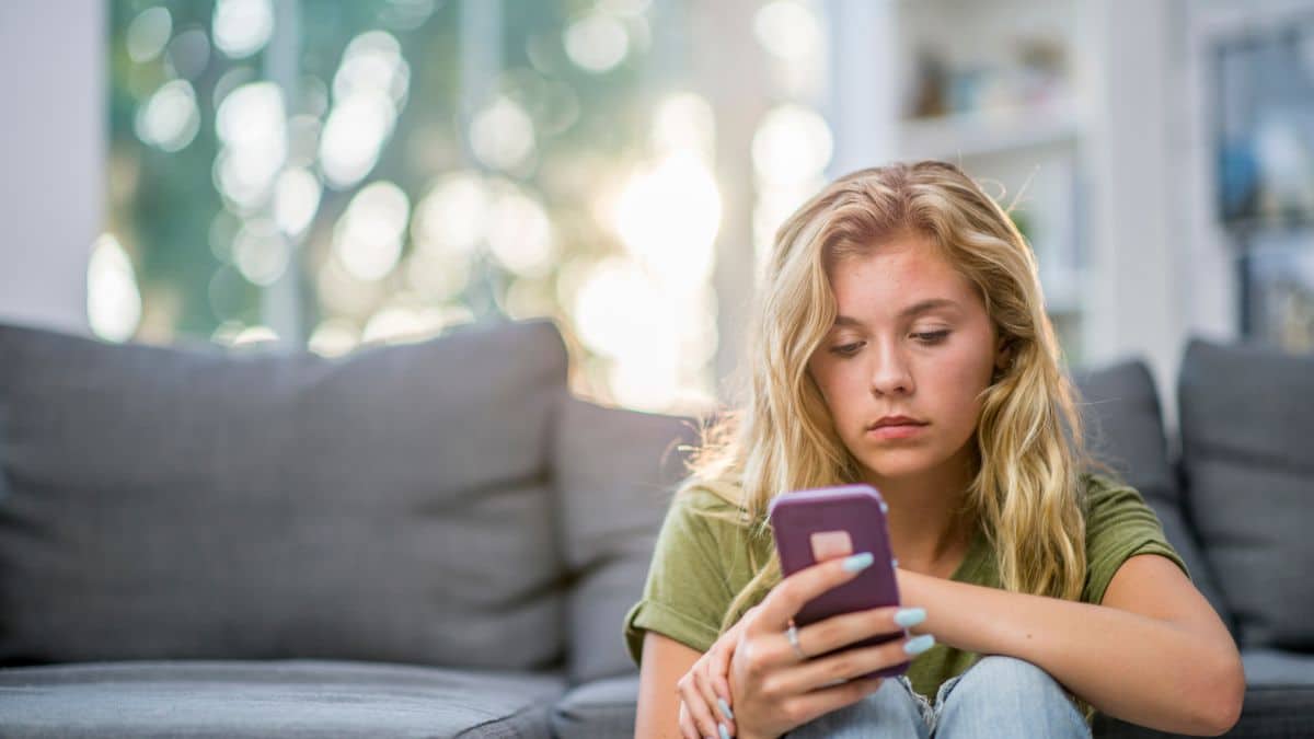 UK parent using a phone at home in the evening