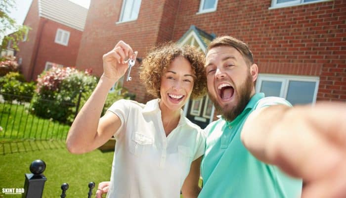 Illustration of a couple holding house keys outside a home