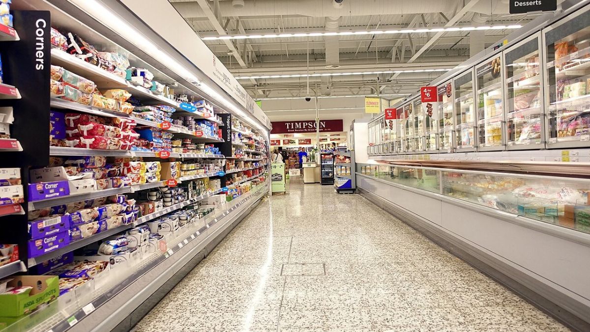 Yoghurts and frozen food lining an aisle in an Asda supermarket