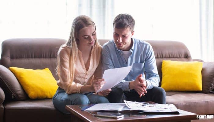 A letter, household bills and calculator on a kitchen table.