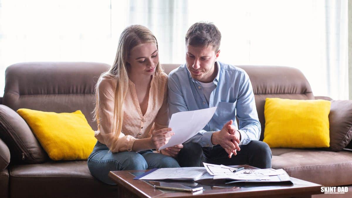 A letter, household bills and calculator on a kitchen table.