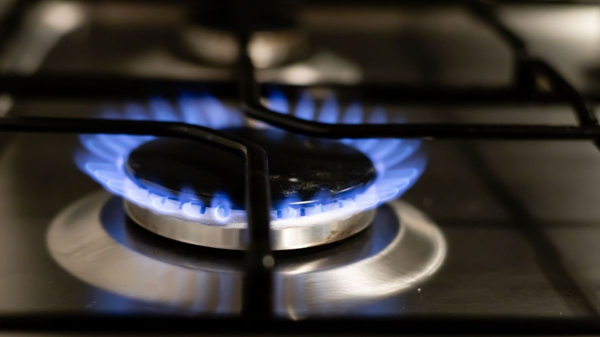 Blue flames burning on a gas hob.